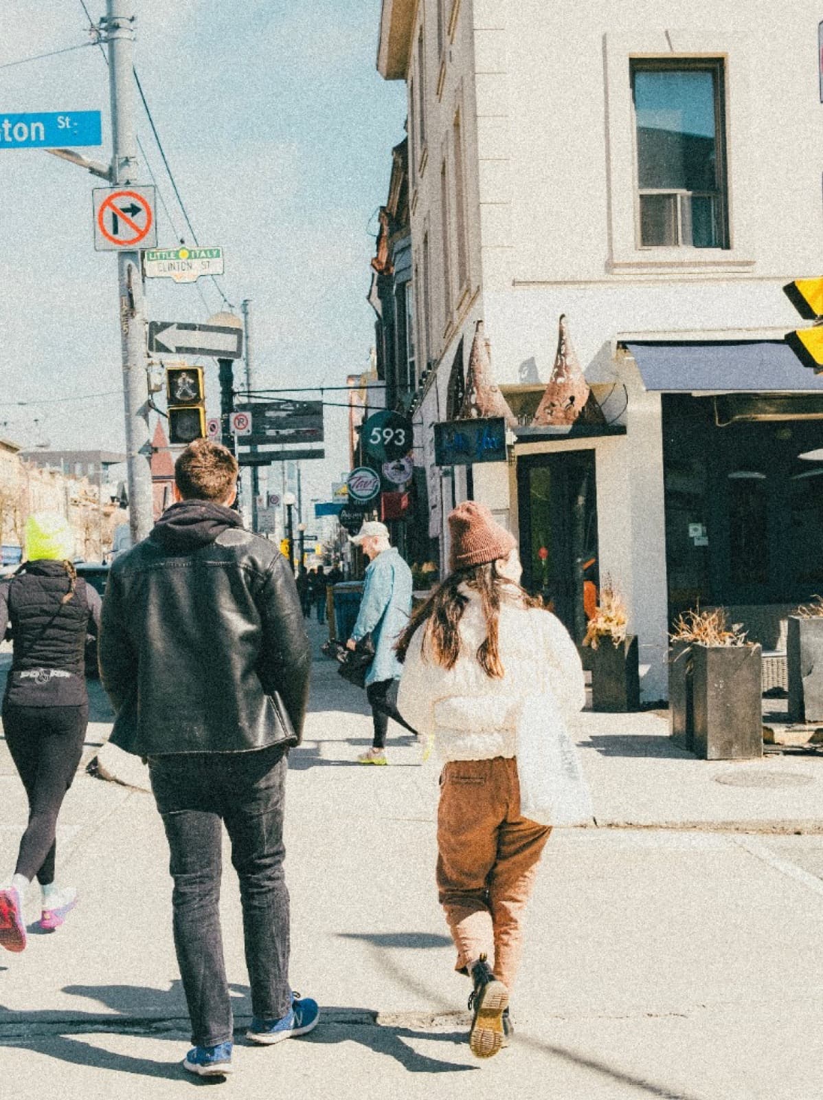 People walking through a vibrant local neighborhood street